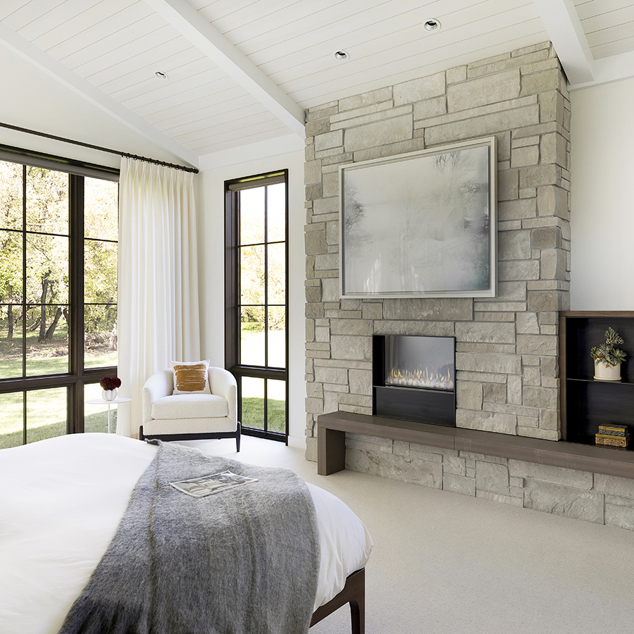 A Hudson™ Sandstone hearth doubles as a seating bench in this peaceful master suite.