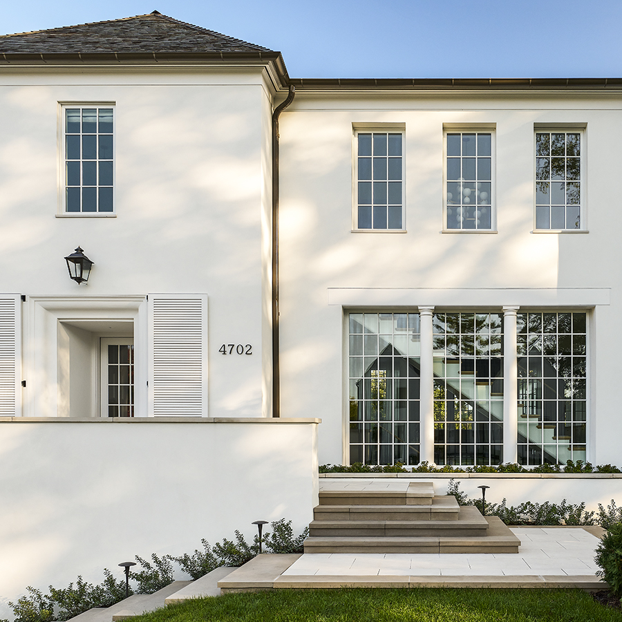 This magnificent entrance features porcelain paving framed by natural stone, creating a durable and low-maintenance walkway.