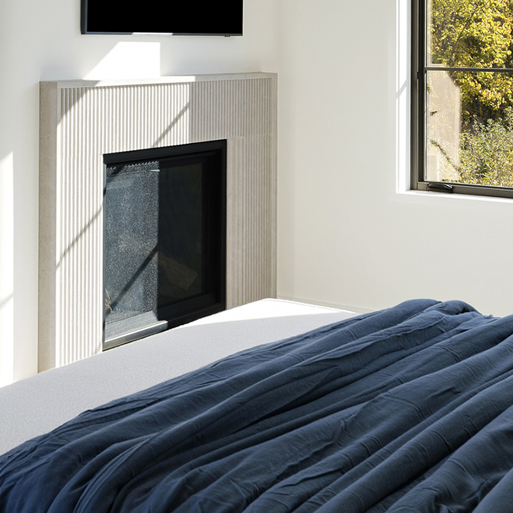 64. Ardeo™ limestone custom fluted fireplace-surround.