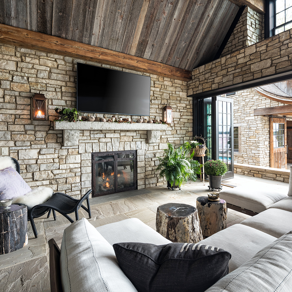 17. Hand-chiseled Limestone mantel, Greydon™ Sandstone hearthstone, and Laurel™ Sandstone tile.